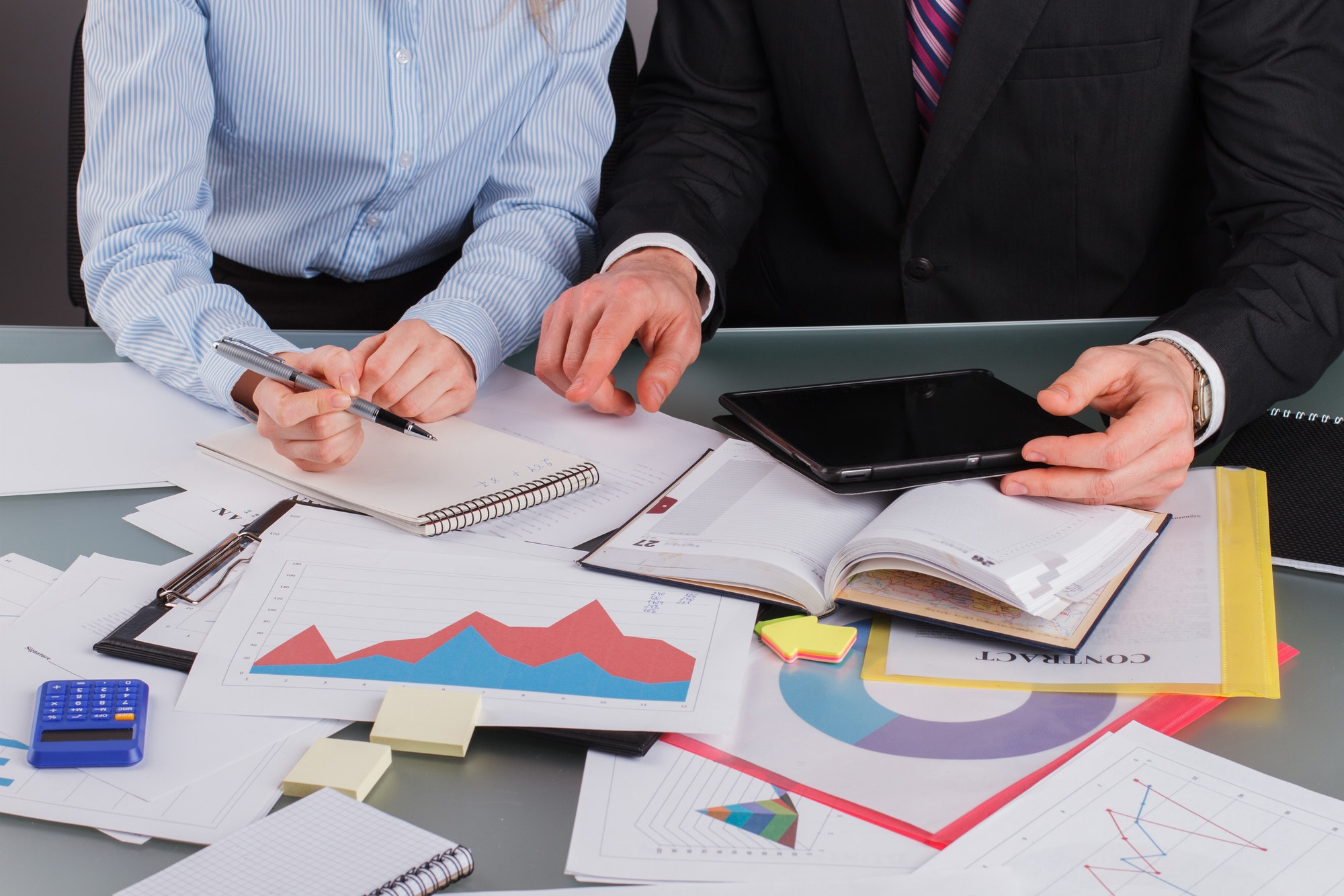 Business people analyzing financial documents.